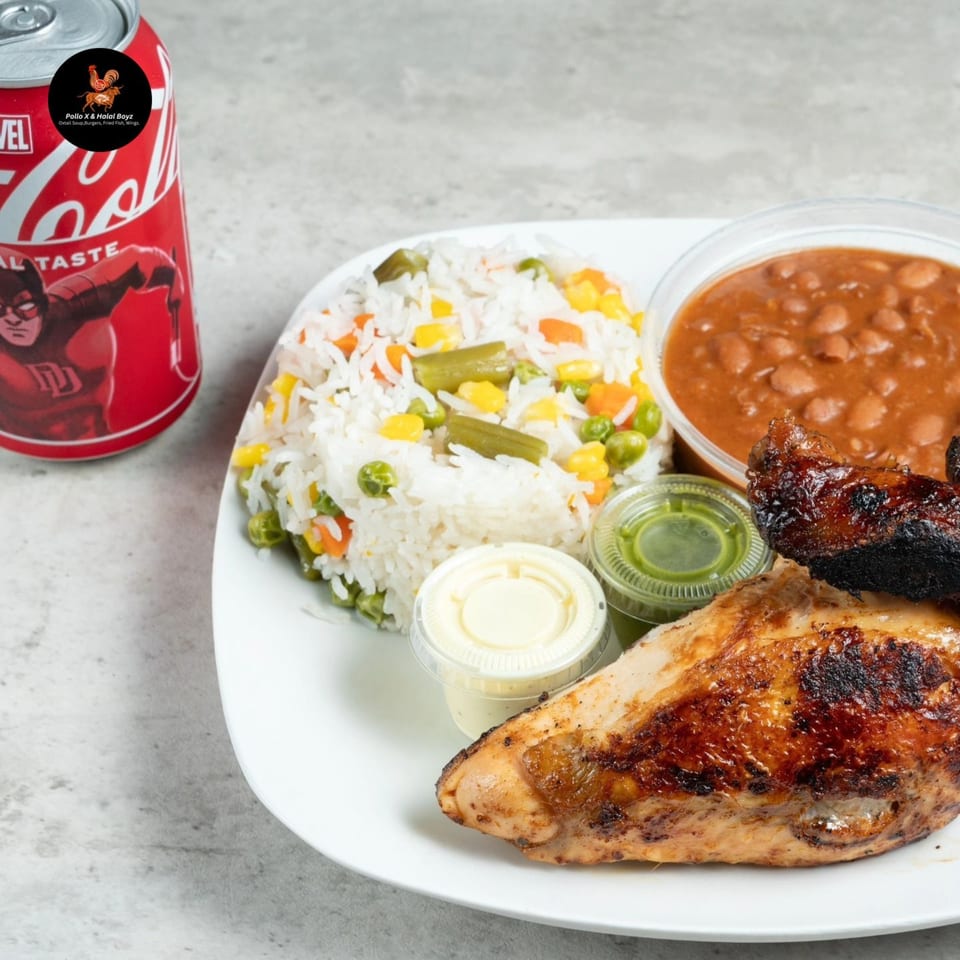 Halal Boyz grilled chicken, rice with vegetables, beans, and sauces, with a Coca-Cola can.