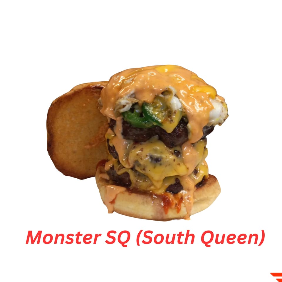 A towering halal burger with multiple patties, melted cheese, egg, and sauce on a bun.