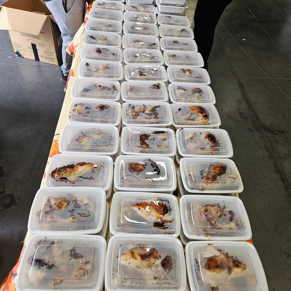 Rows of clear plastic containers filled with cooked halal chicken, ready for takeout.