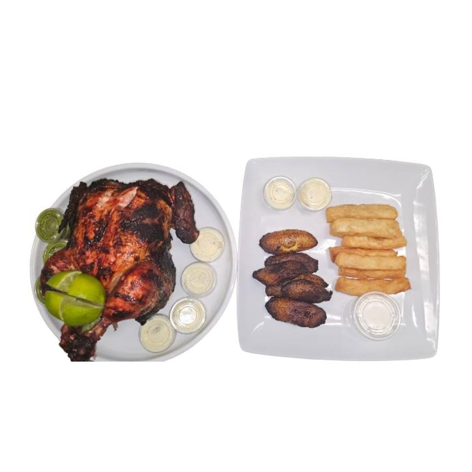 Halal whole roasted chicken with lime, green and white sauces, fried plantains, and yucca fries.