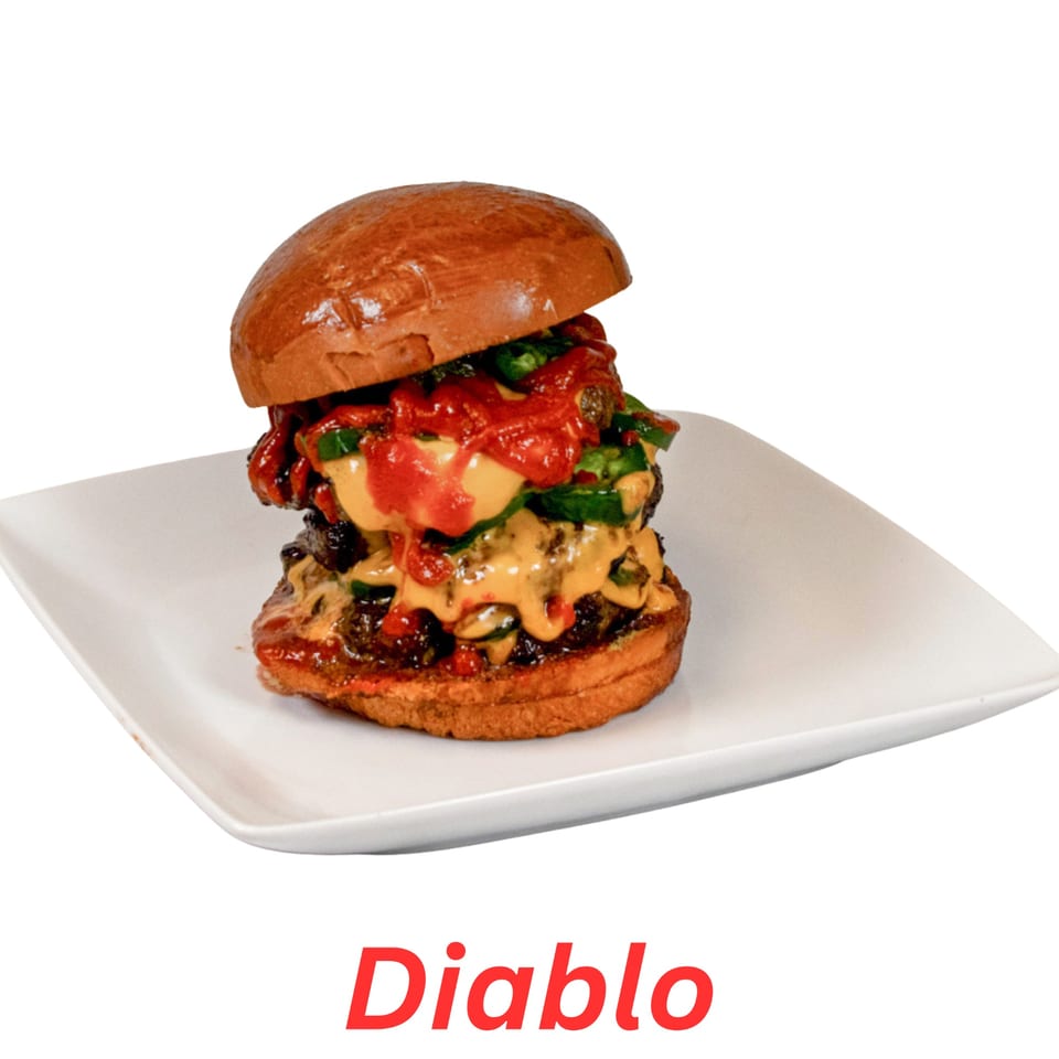 A double-patty Diablo burger with cheese, jalapeños, and red sauce on a white plate.