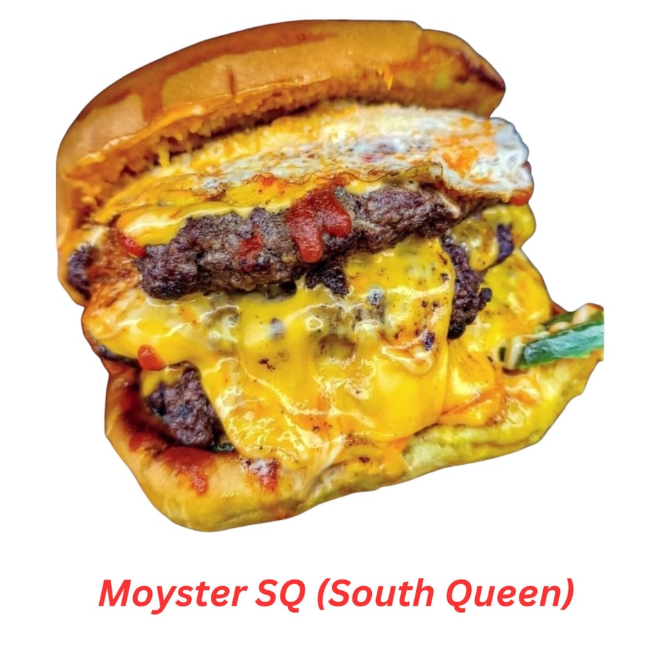 A double halal burger with melted cheese, ketchup, and a fried egg on a bun.